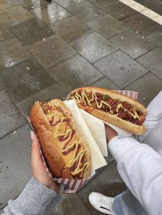 two hot dogs with mustard and ketchup on them