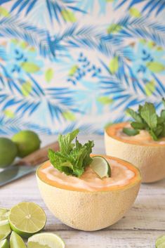 two small bowls filled with food and garnished with limes