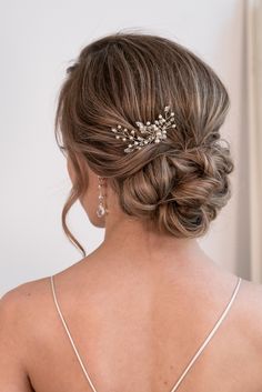 the back of a woman's head wearing a bridal hair piece