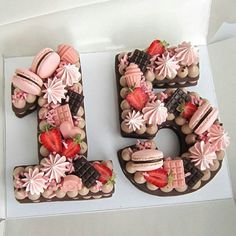 a cake in the shape of the number twenty five decorated with chocolate and strawberries