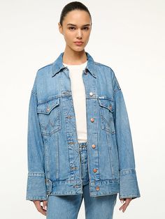 THE BIGGEST JEAN JACKET The Biggest Jean Jacket is our oversized must-have jacket from the Wrangler + STAUD collection. Drop shoulder detailing and exaggerated cuff create a laid-back look. Relaxed Fit Medium Wash Outerwear With Button Cuffs, Relaxed Fit Outerwear With Button Cuffs In Medium Wash, Oversized Denim Jacket With Button Cuffs For Spring, Urban Denim Blue Jacket With Button Closure, Blue Urban Denim Jacket With Button Closure, Oversized Denim Outerwear With Button Closure, Vintage Oversized Denim Jacket With Button Closure, Urban Blue Button-up Denim Jacket, 90s Denim Jacket