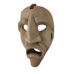 a wooden mask with an evil look on it