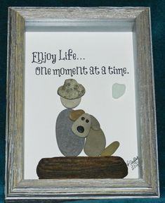 a picture frame with an image of a dog and a mushroom on it that says, enjoy life the moment at a time