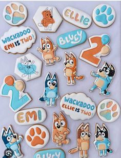 an assortment of decorated cookies in the shape of dogs and cats with words on them