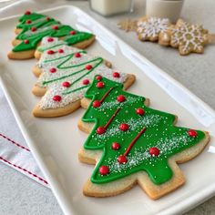 christmas cookies decorated with icing on a white plate