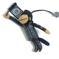 a small stuffed monkey with a black hat and scarf on it's head is laying down