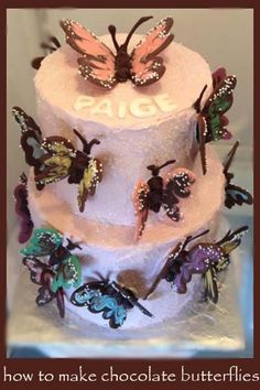 a three tiered cake with butterflies on it