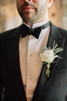 a man in a tuxedo with a boutonniere on his lapel