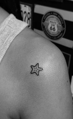 a person with a small star tattoo on their shoulder