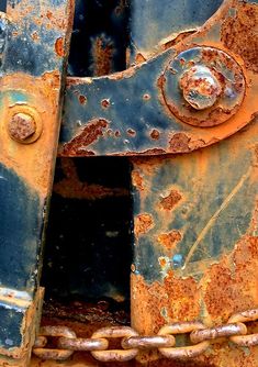 an old rusted metal door with chains on it