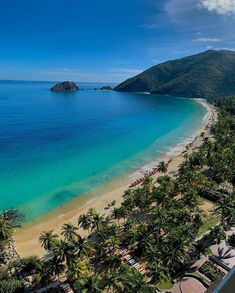 the beach is surrounded by palm trees and blue water