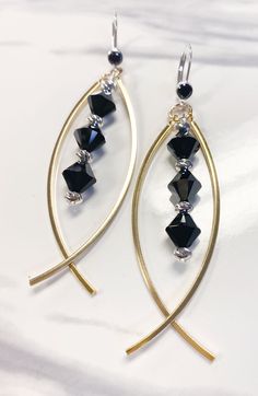 black and gold earrings on white background