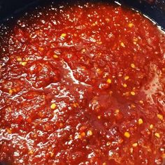 a large pot filled with sauce sitting on top of a stove