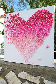 a heart made out of pink butterflies on a white canvas with the words ometiza com