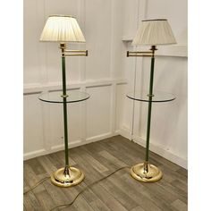 pair of brass and glass table lamps with shades on each lamp, circa 1950's