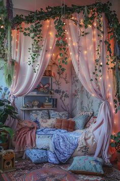 a bedroom with pink curtains and plants hanging from the ceiling, on top of a bed