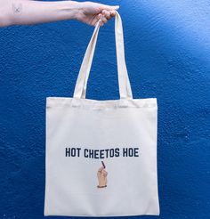 Hot Cheetos Hoe Tote is for all those spicy peeps who love hot cheetos! With its durable canvas material, it's ideal for groceries, everyday essentials, books, gym or your shopping bag to put your Hot Cheetos in and tell everyone how much you love them! It's the perfect tote bag! Canvas Tote Bags, 15 x 16 inches Heavy Duty and Durable: Crafted with premium materials, our tote bags are built to last! Eco-Friendly Choice: Make a sustainable statement with our bags! Say goodbye to disposable paper and plastic and a greener lifestyle. How to clean: Just give it a wipe down or spot clean it. Satisfaction Guaranteed: Your satisfaction is our priority! We're confident that you'll love your product, but if for any reason you're not completely satisfied, please don't hesitate to contact us. We'll d Custom Hot Cheetos Bag, Hot Cheetos, Green Lifestyle, Perfect Tote Bag, Gift For Friend, Women Bag, Bag For Women, Just Giving, Canvas Material