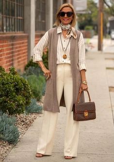 How to wear a long vest: Nora in a long knitted cardigan, shirt and trousers | 40plusstyle.com Style Long Vest, Long Vest Outfits For Women, Long Vest Outfit, Long Knit Vest, Long Knitted Cardigan, Long Cardigan Outfit, Long Sleeveless Cardigan, Vest Outfits For Women, Sleeveless Kimono