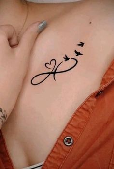 a woman's chest with birds flying around it and the word love written in cursive font