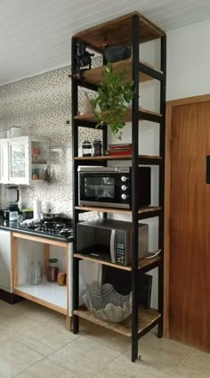 a kitchen with an oven, microwave and shelves