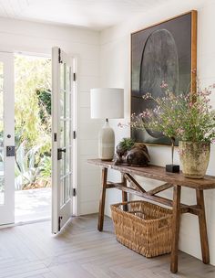 an entryway with flowers and plants on the table in front of it that says garden ideas & 7 pro tips, country of hollywood's go - to guys