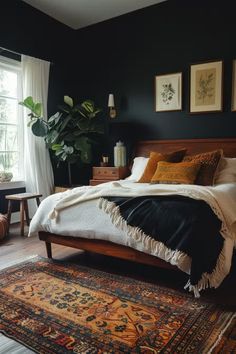 a bedroom with black walls and rugs on the floor next to a large bed