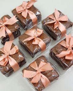 six brownies wrapped in plastic with pink bows