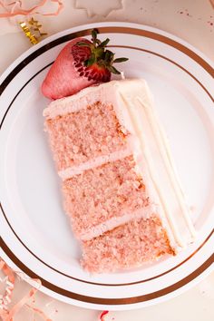 a piece of cake on a plate with strawberries