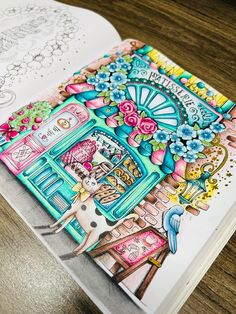 an open coloring book on a wooden table