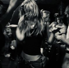 black and white photograph of a woman dancing in front of a group of other people