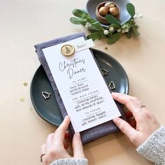 a person holding a menu on top of a plate