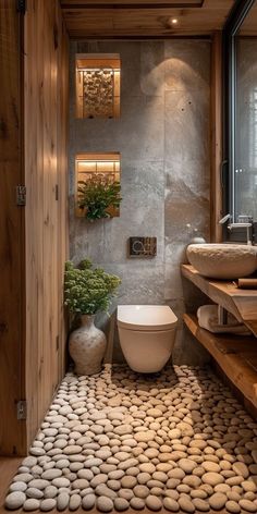 a bathroom with rocks on the floor and walls