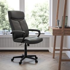 an office chair sitting in front of a window