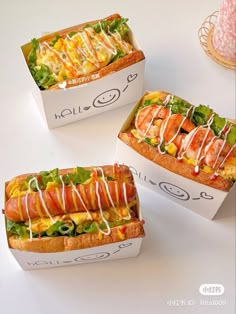 three sandwiches with different toppings are sitting on a white counter top next to each other