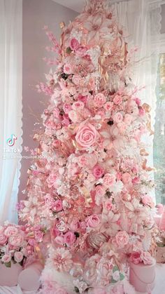 a very pretty pink christmas tree decorated with flowers