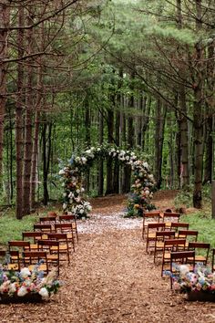 an outdoor ceremony set up in the woods