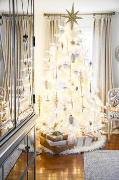 a white christmas tree in a living room