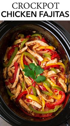 chicken and peppers in a slow cooker with cilantro garnishes