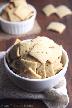 a bowl filled with crackers on top of a wooden table