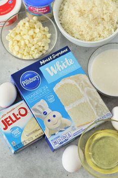 ingredients to make an egg cake laid out on a counter top with eggs, milk, and flour