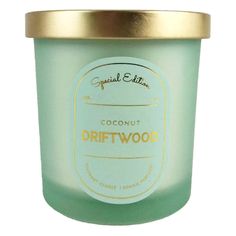 coconut driftwood candle in a glass jar with gold lid and label on the front