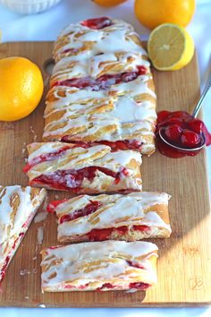 lemon and raspberry scones on a cutting board with oranges in the background