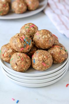 a white plate topped with cookies covered in sprinkles