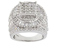 a white gold ring with baguetts and diamonds on the sides, set against a white background