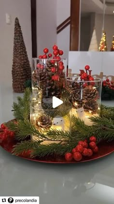 a christmas centerpiece with pine cones and candles