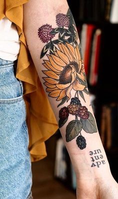 a woman with a sunflower tattoo on her arm