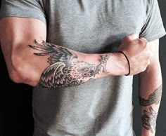 a man with a tattoo on his arm and an eagle in the middle of his arm