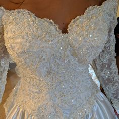 the back of a wedding dress with beading on it