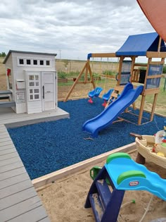 children's play area with swings, slides and sand