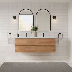 a bathroom with two sinks and mirrors on the wall